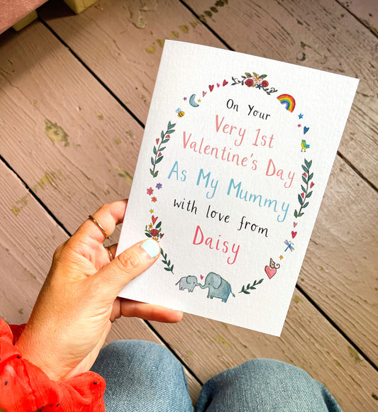 Hand holding a Valentine's Day card with a personalised name for a new mum on a wooden surface