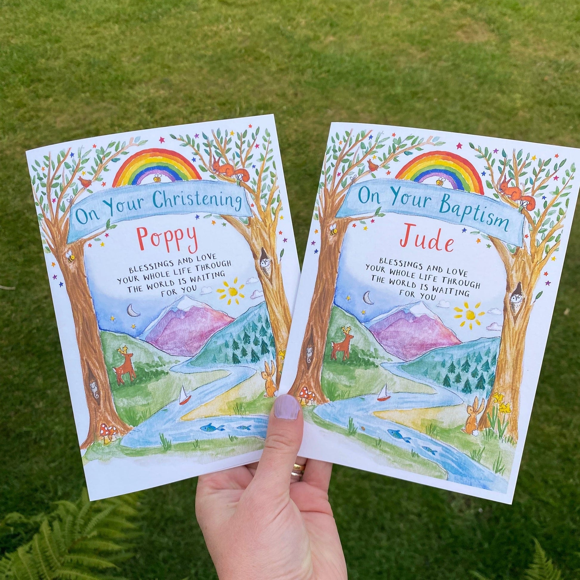 hand holding two personalised cards for children on their christening and baptism