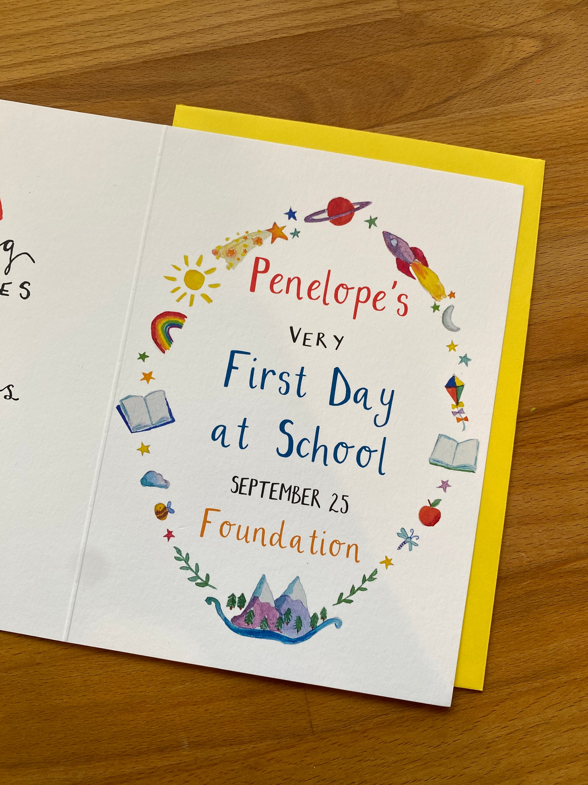 greetings card for Penelope's very first day at school on a wooden surface