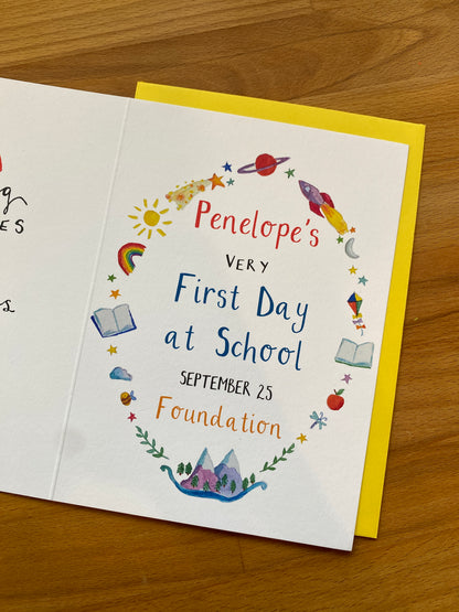greetings card for Penelope's very first day at school on a wooden surface