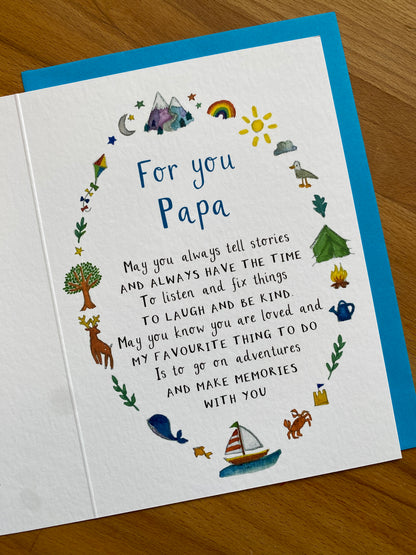 Greeting card for Papa with illustrations and text on a wooden surface