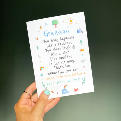 hand holding a white greetings card with the text 'grandad' at the top, a poem underneath and watercolour illustrations surrounding it.
