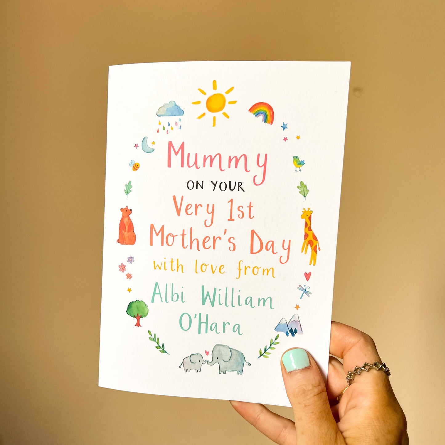 hand holding a personalised mother's day card featuring child's name and watercolour animal illustrations