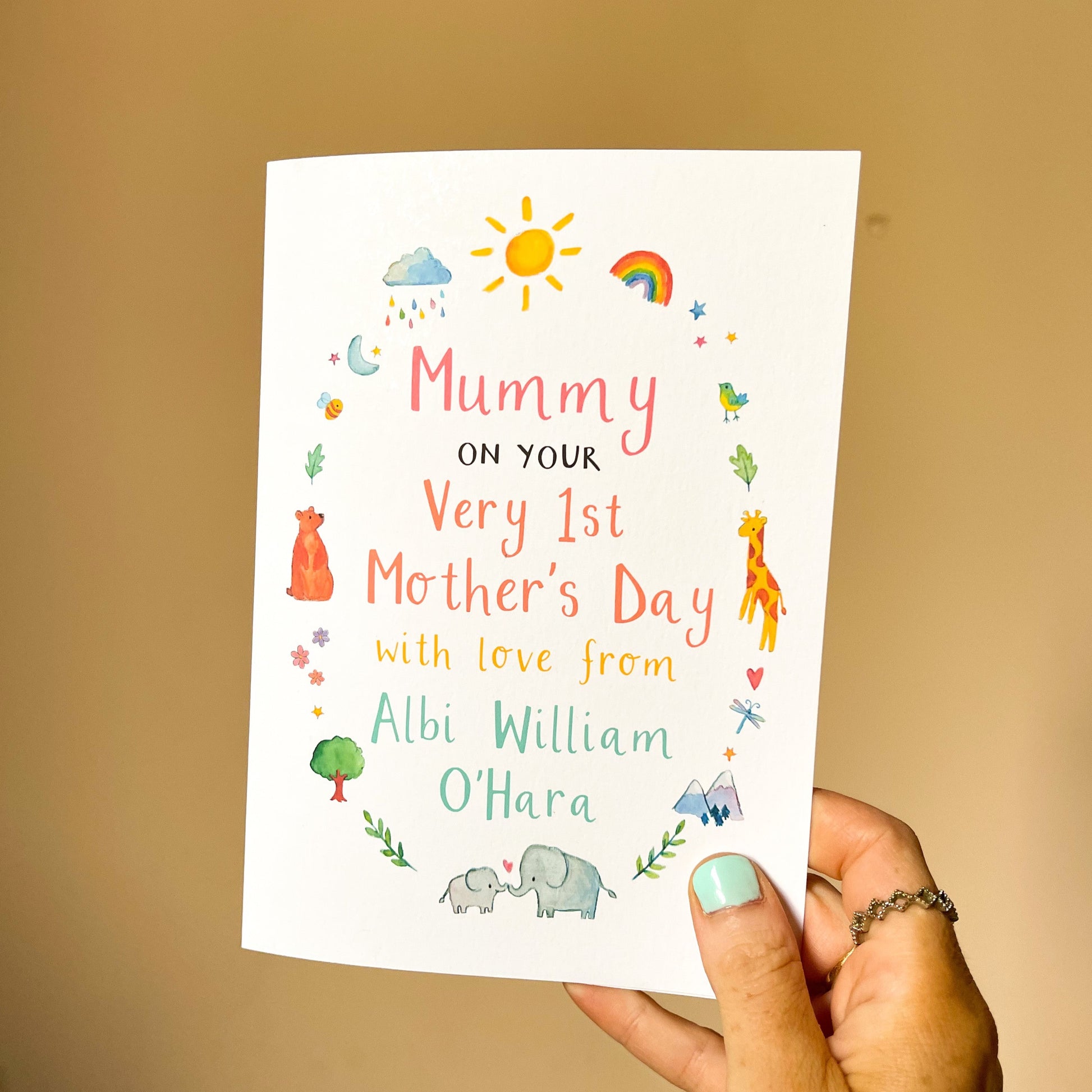 hand holding a personalised mother's day card featuring child's name and watercolour animal illustrations
